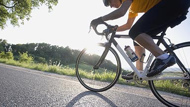 someone biking on an empty road