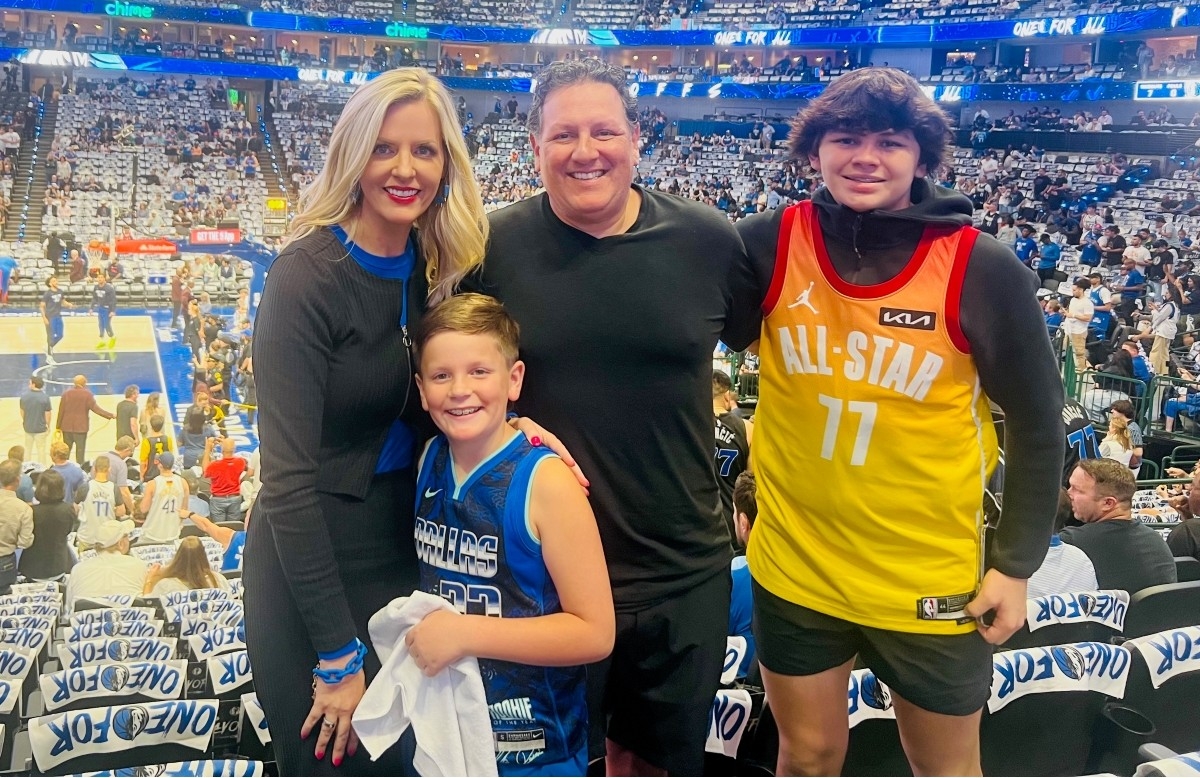 Patient Cassie Munoz and her family at a Dallas Mavericks game.