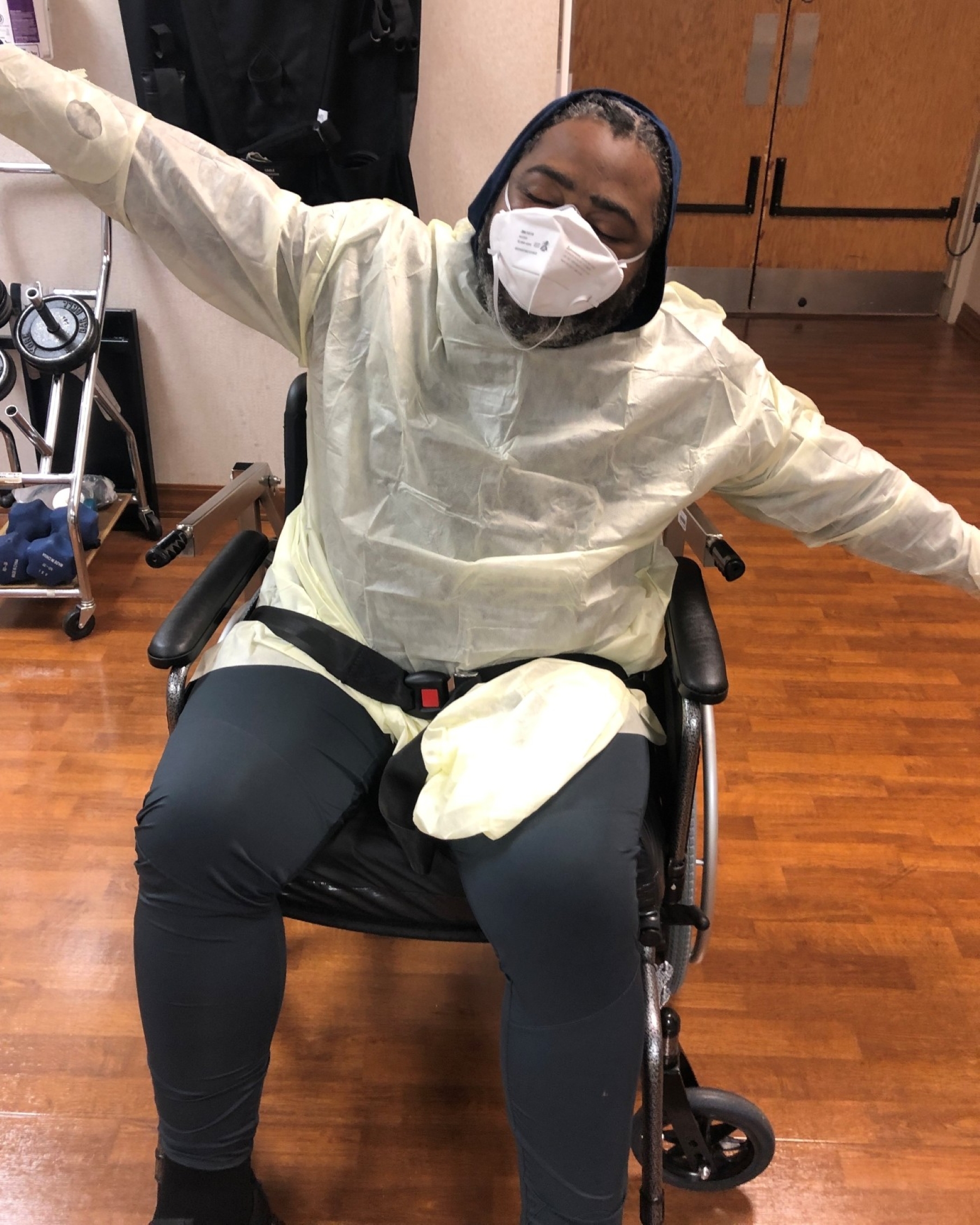 Clinton Adger wearing mask and sitting in wheelchair