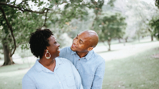 Couple outside, smiling at each other