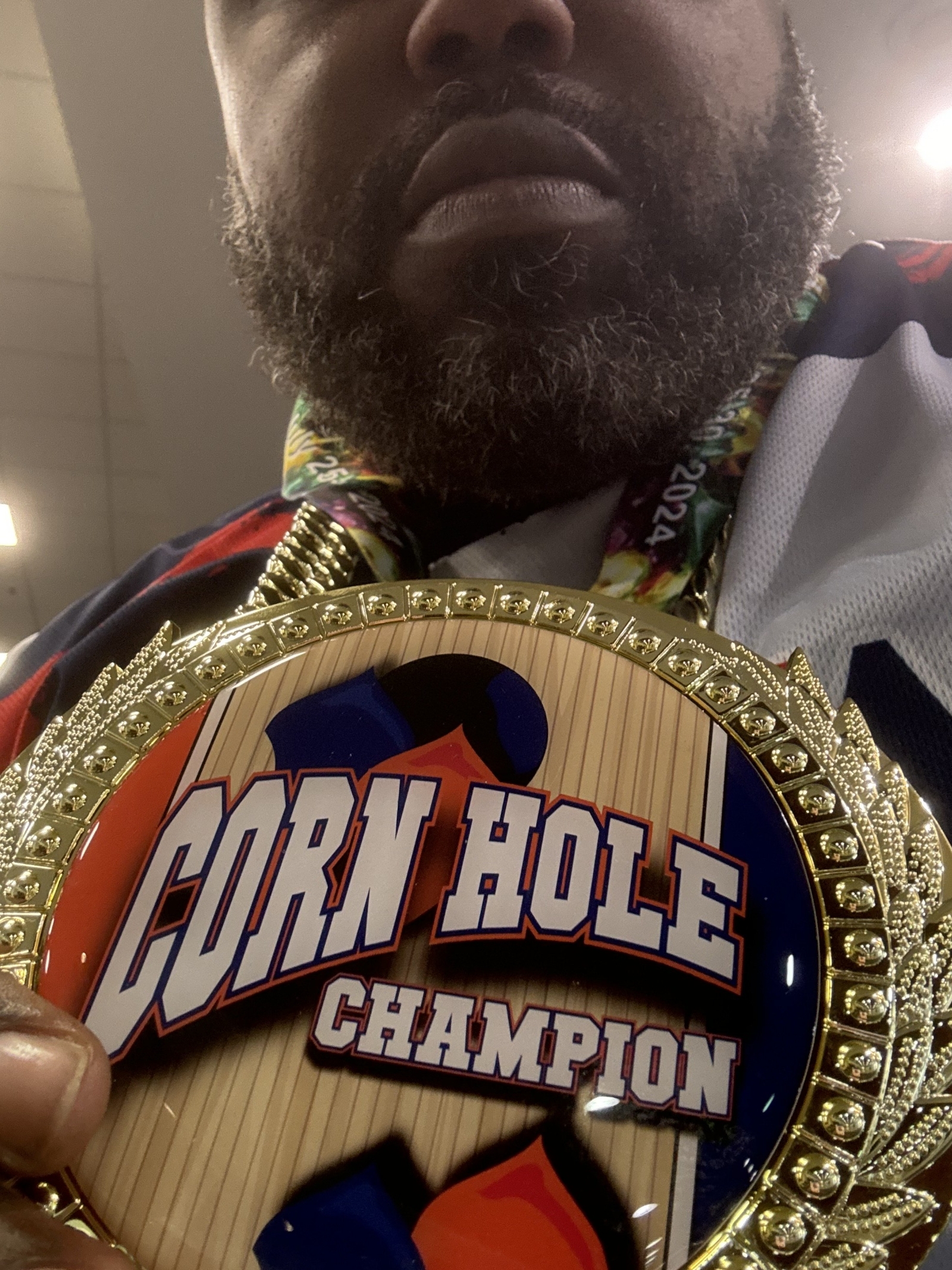 patient Clinton Adger with corn hole medal