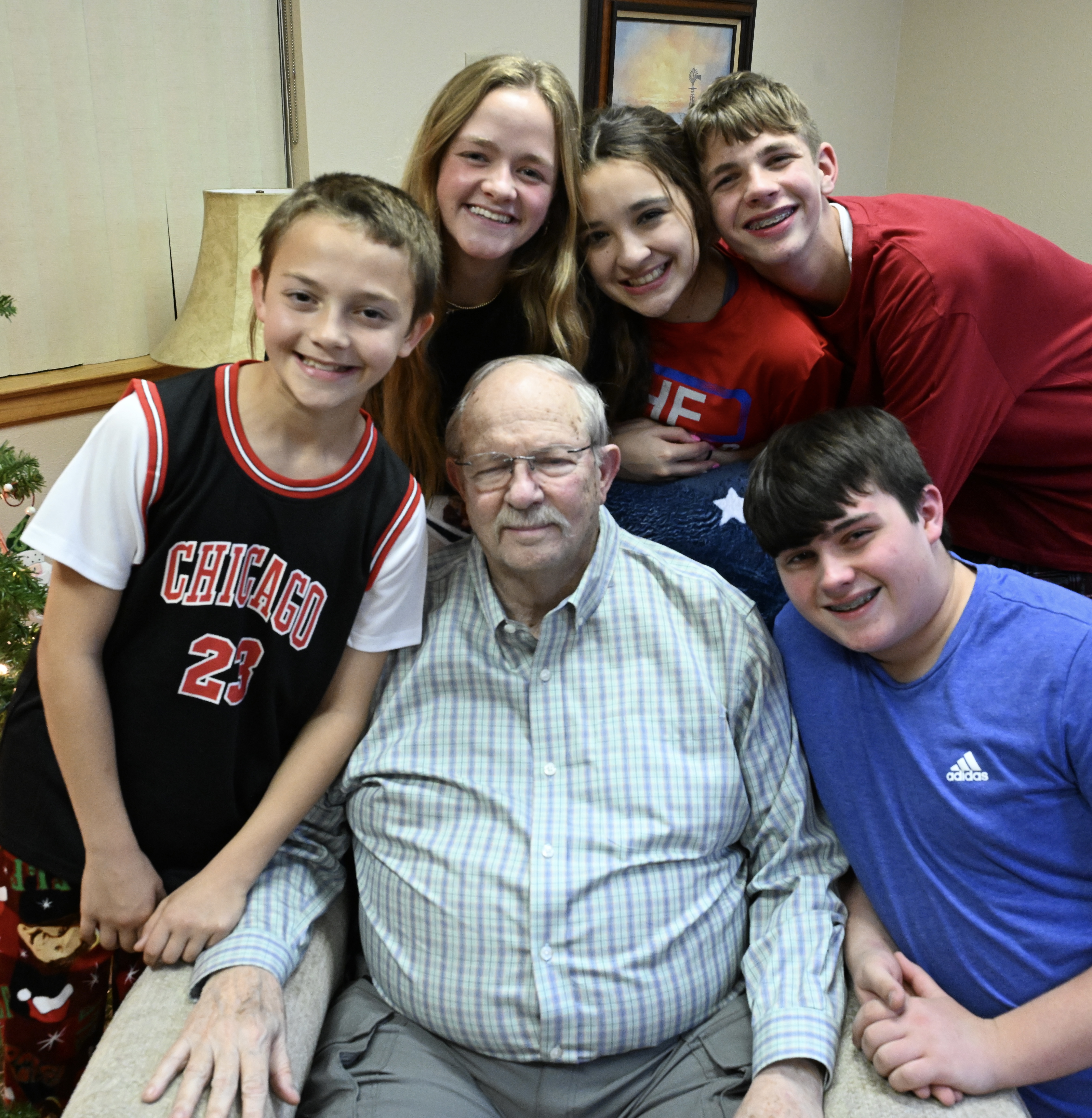 Patient Dan Dudley surrounded by grandchildren