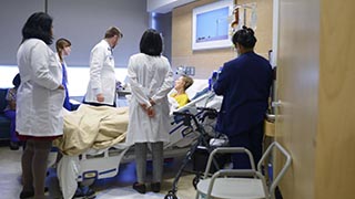 doctors and residents with a patient