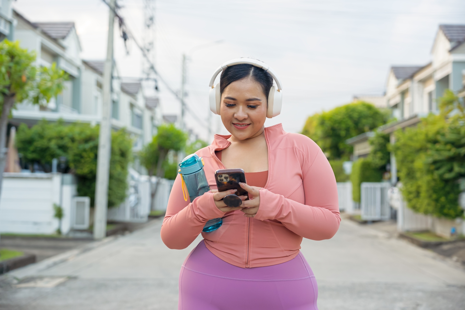Woman in exercise gear taking a break to check phone