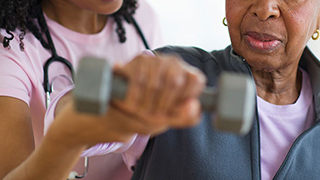 A patient performs strength exercises under supervision.
