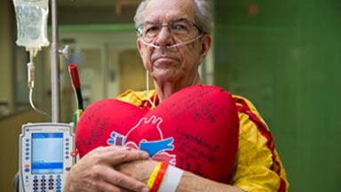 Recovering patient holding heart pillow