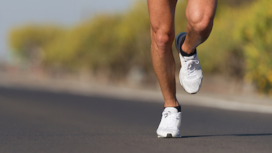 one pair of feet running on a road