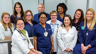 A diverse group of healthcare professionals posing for a group photo.